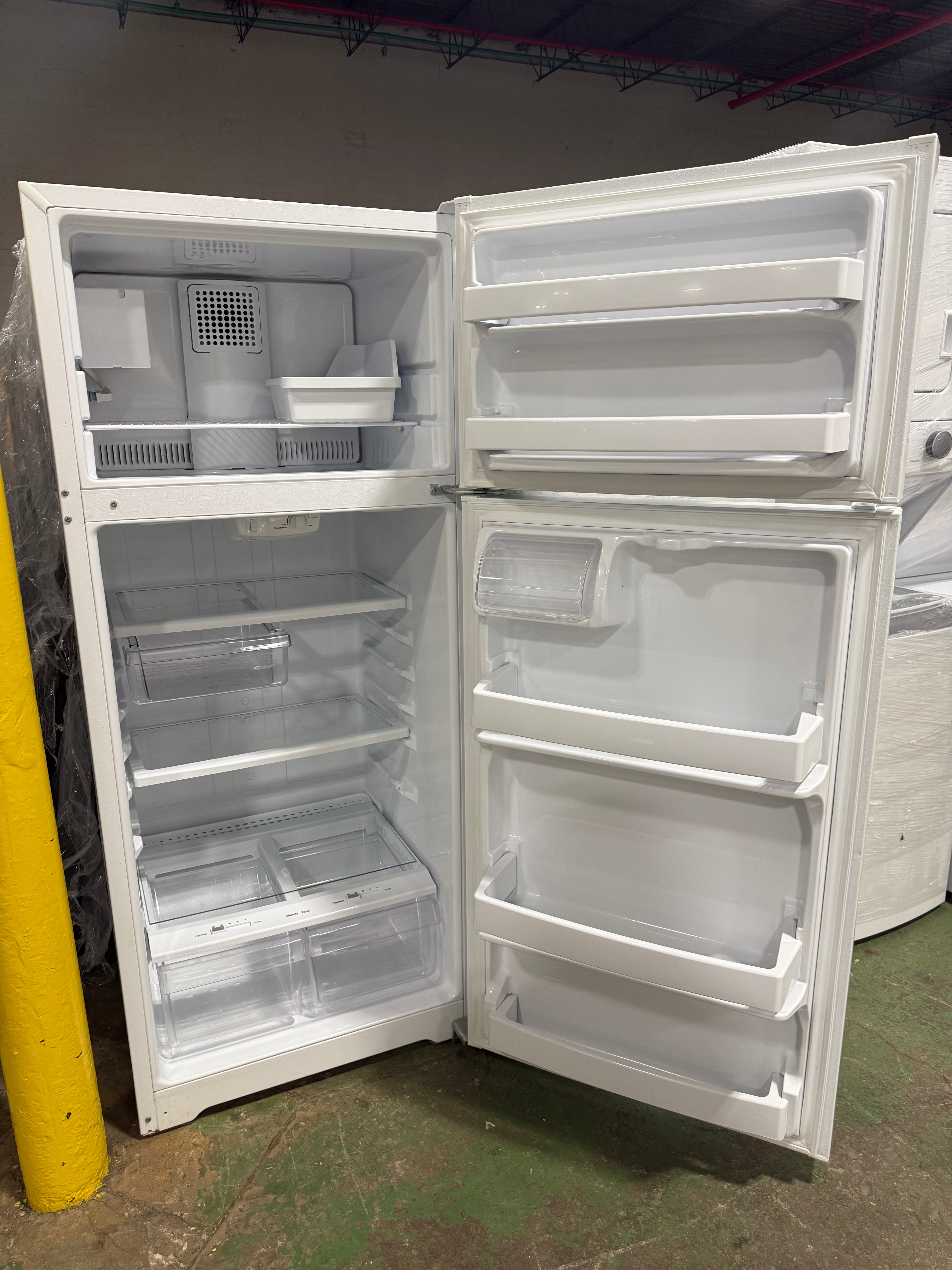 Interior view showing adjustable glass shelves inside GE 17.5 cu.ft. refrigerator from SHL