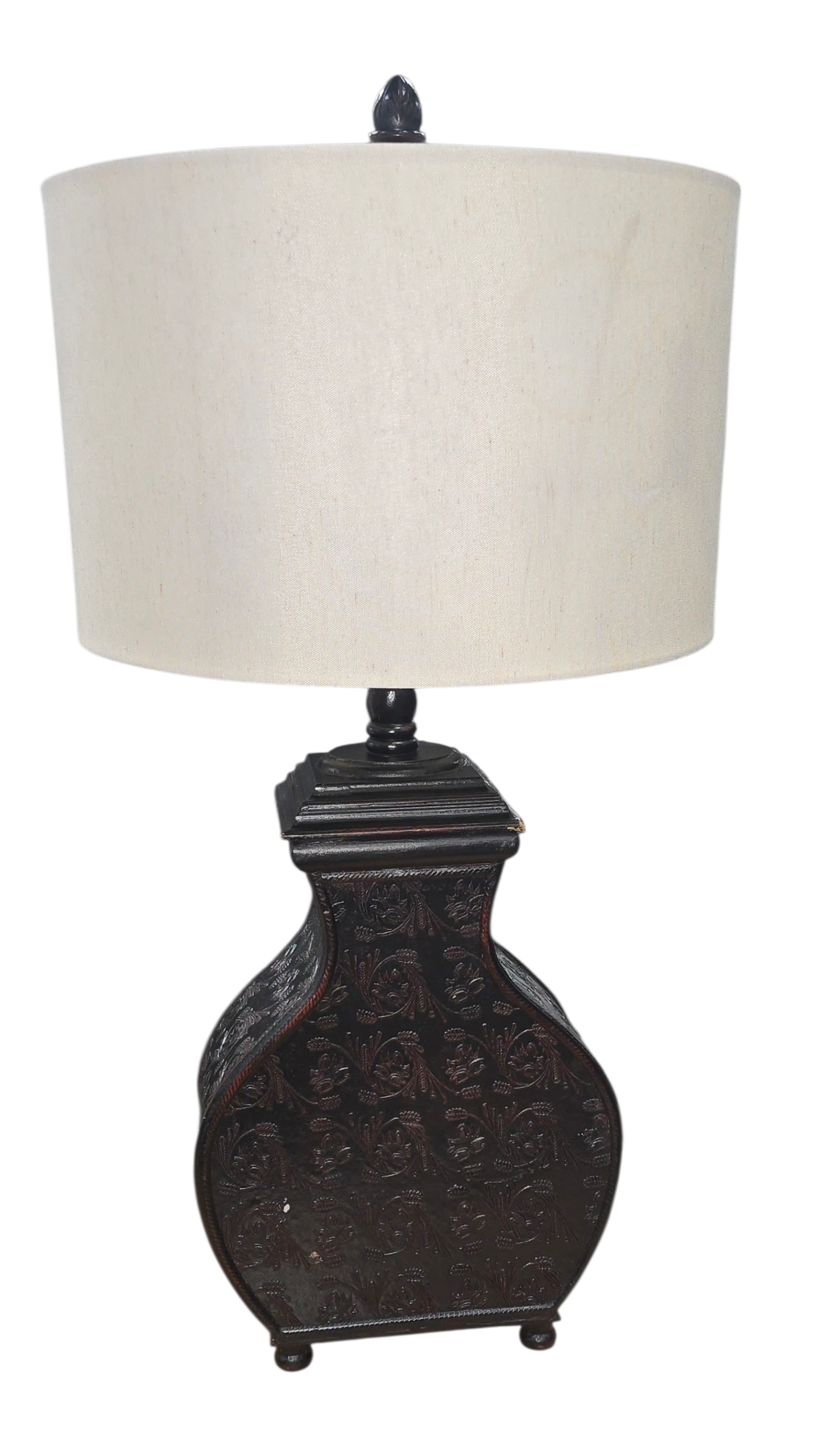 Front view of dark wood vase-shaped table lamp with carved floral design
