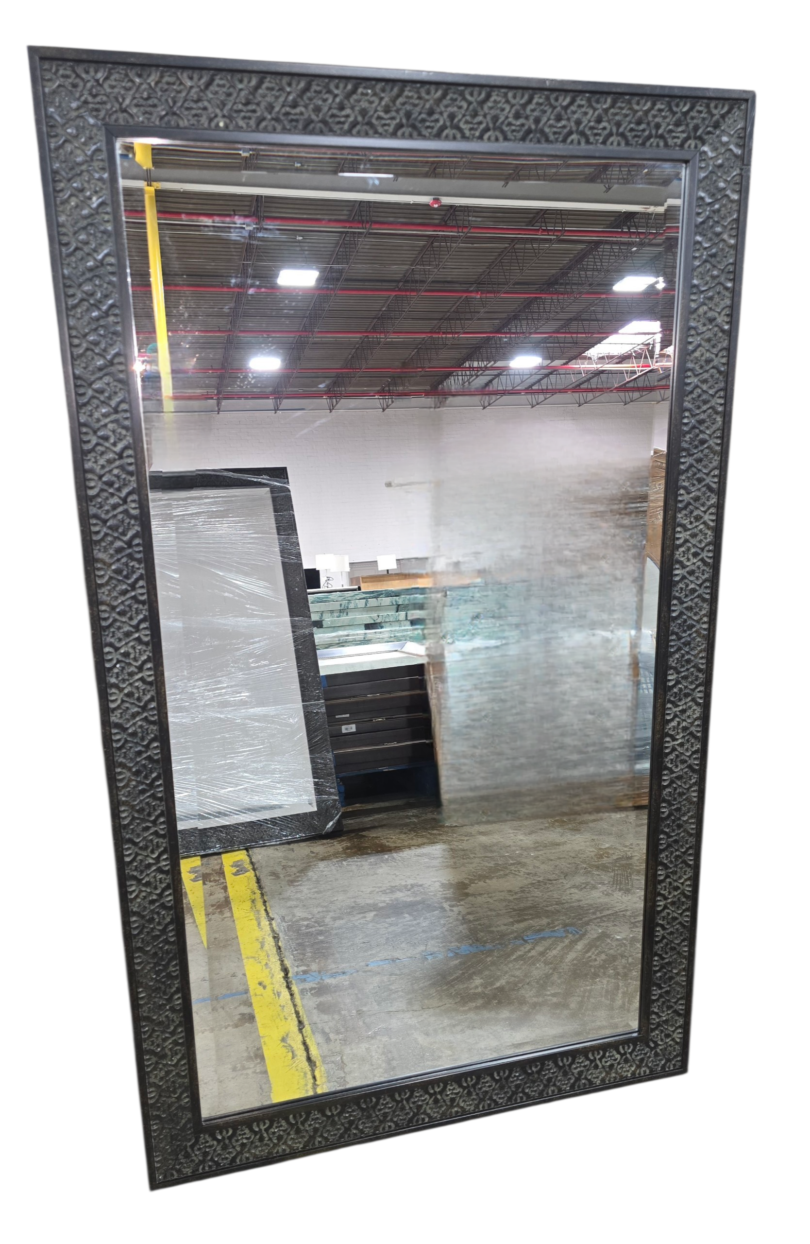 Decorative wall mirror with ornate dark frame measuring 31.25 x 53.25 inches, used and in good condition