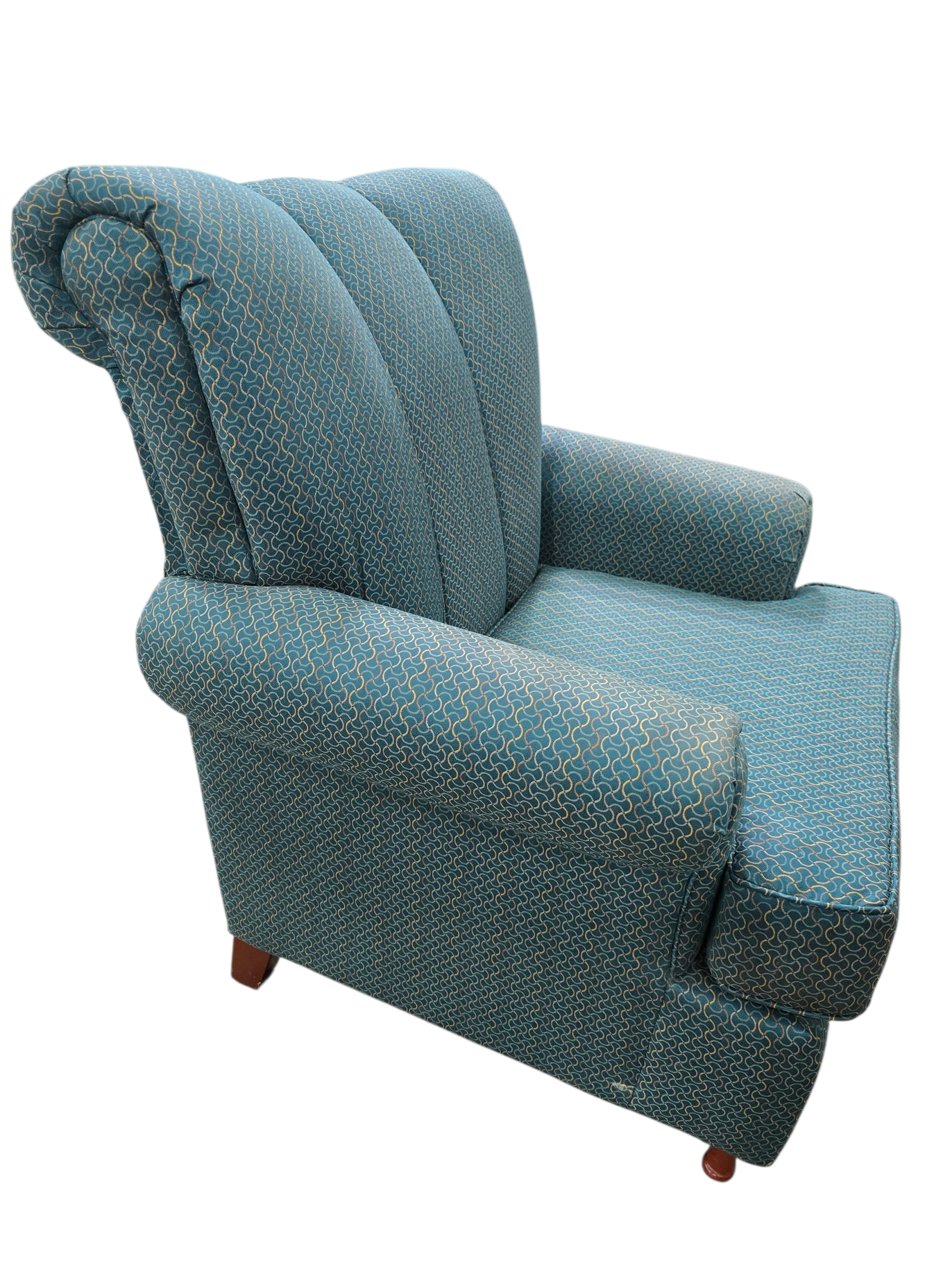 Side view of teal fabric accent chair