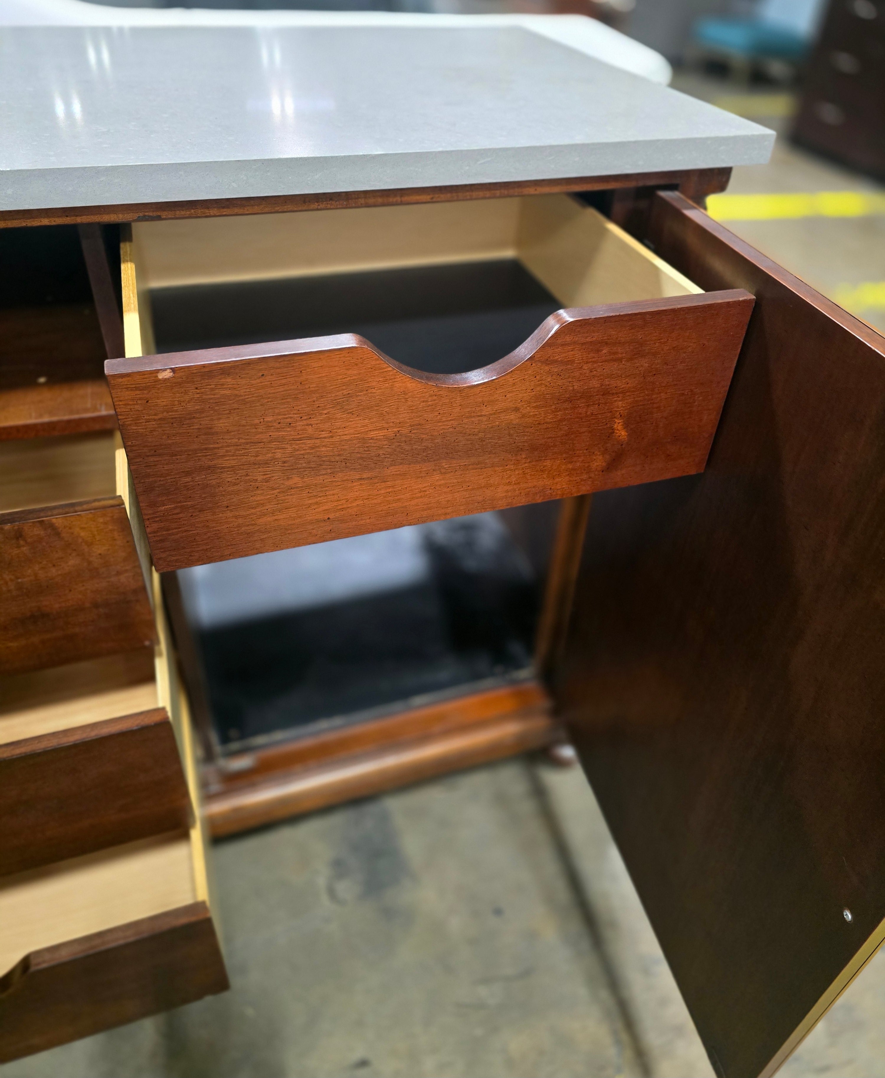 Close-up of the interior storage drawer inside a used American of Martinsville mini fridge cabinet with gray granite top. Available at Southern Hospitality Liquidation in Cartersville, GA near Atlanta, Marietta, Kennesaw, and Rome.
