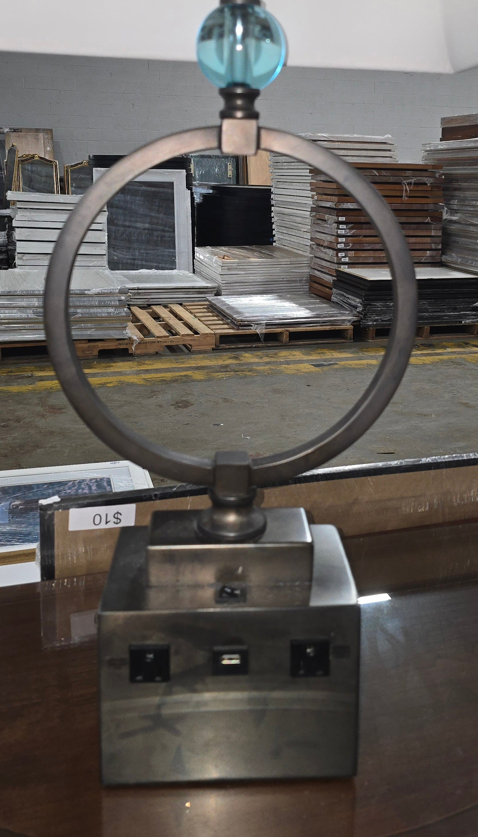 SHL close-up of bronze ring table lamp featuring blue glass accent, one USB charging port, and dual built-in power outlets sourced from an upscale resort