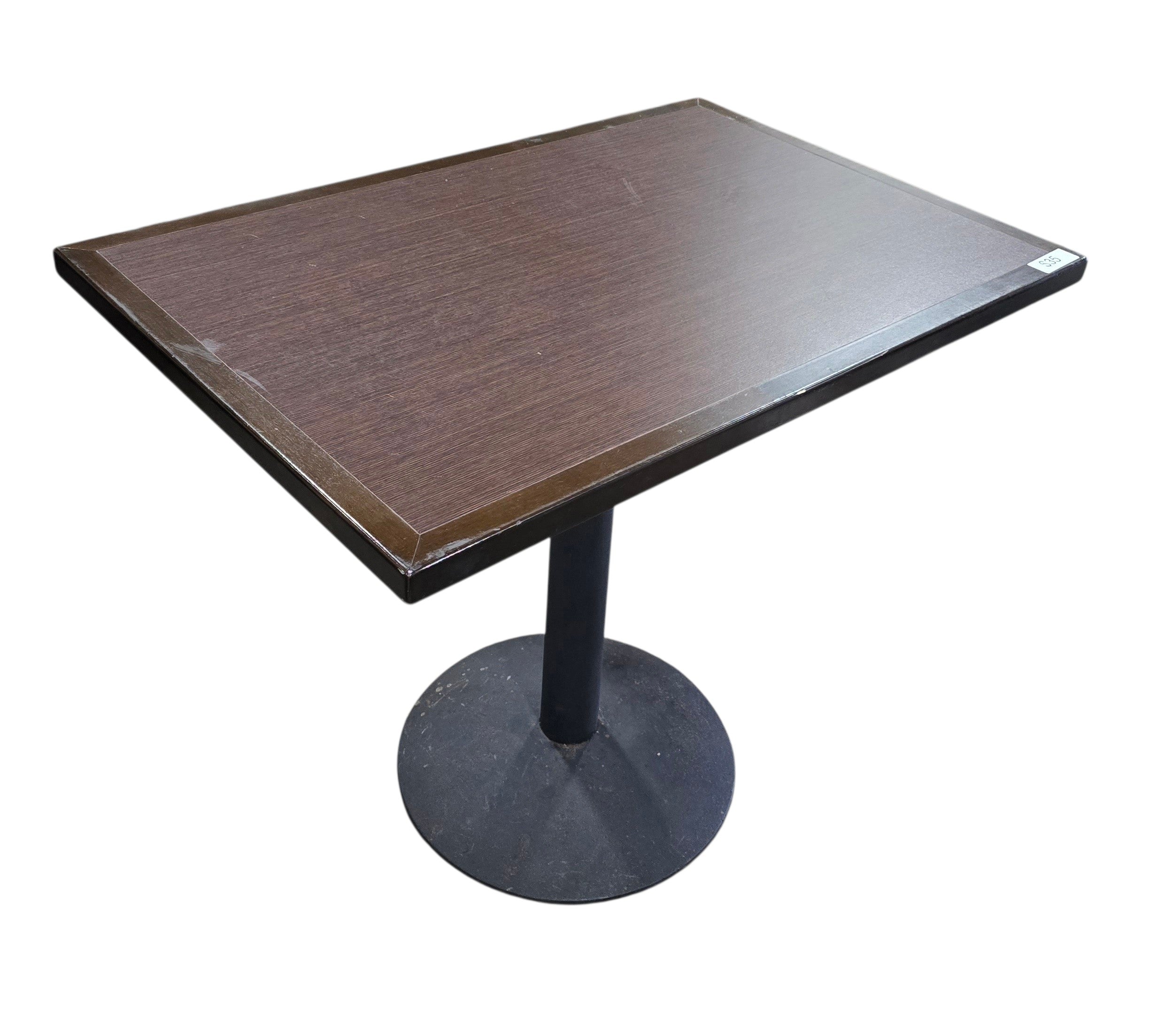 Quality used resort dining table featuring a dark wood rectangular top and black metal pedestal base