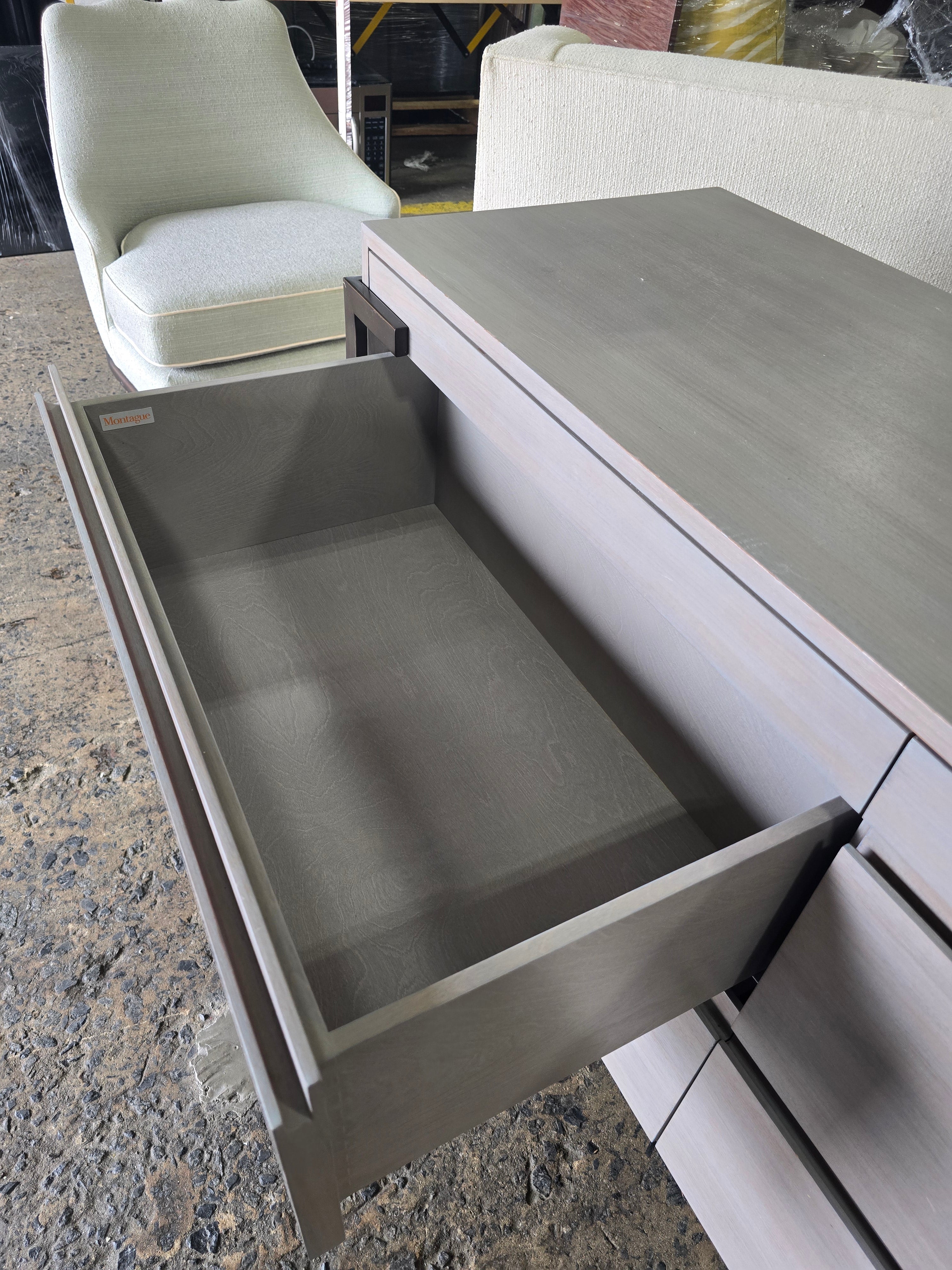 Used Montague 4 drawer gray wood dresser with soft close drawers, showing open drawer detail, sourced from an upscale resort by Southern Hospitality Liquidation in Cartersville, GA near Atlanta, Marietta, Kennesaw, and Rome.