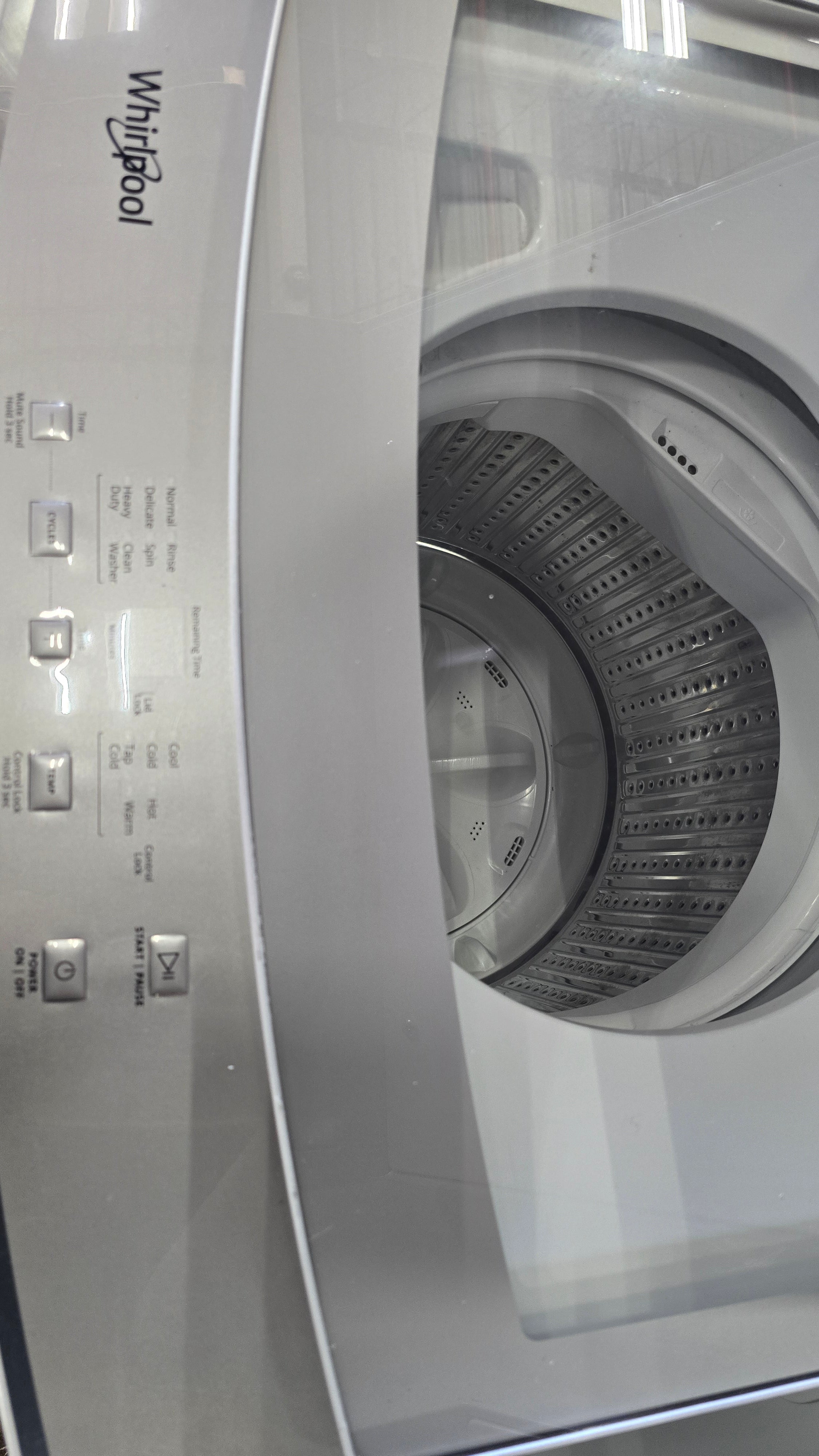 Modern Whirlpool stacked washer dryer combo with transparent washer lid
