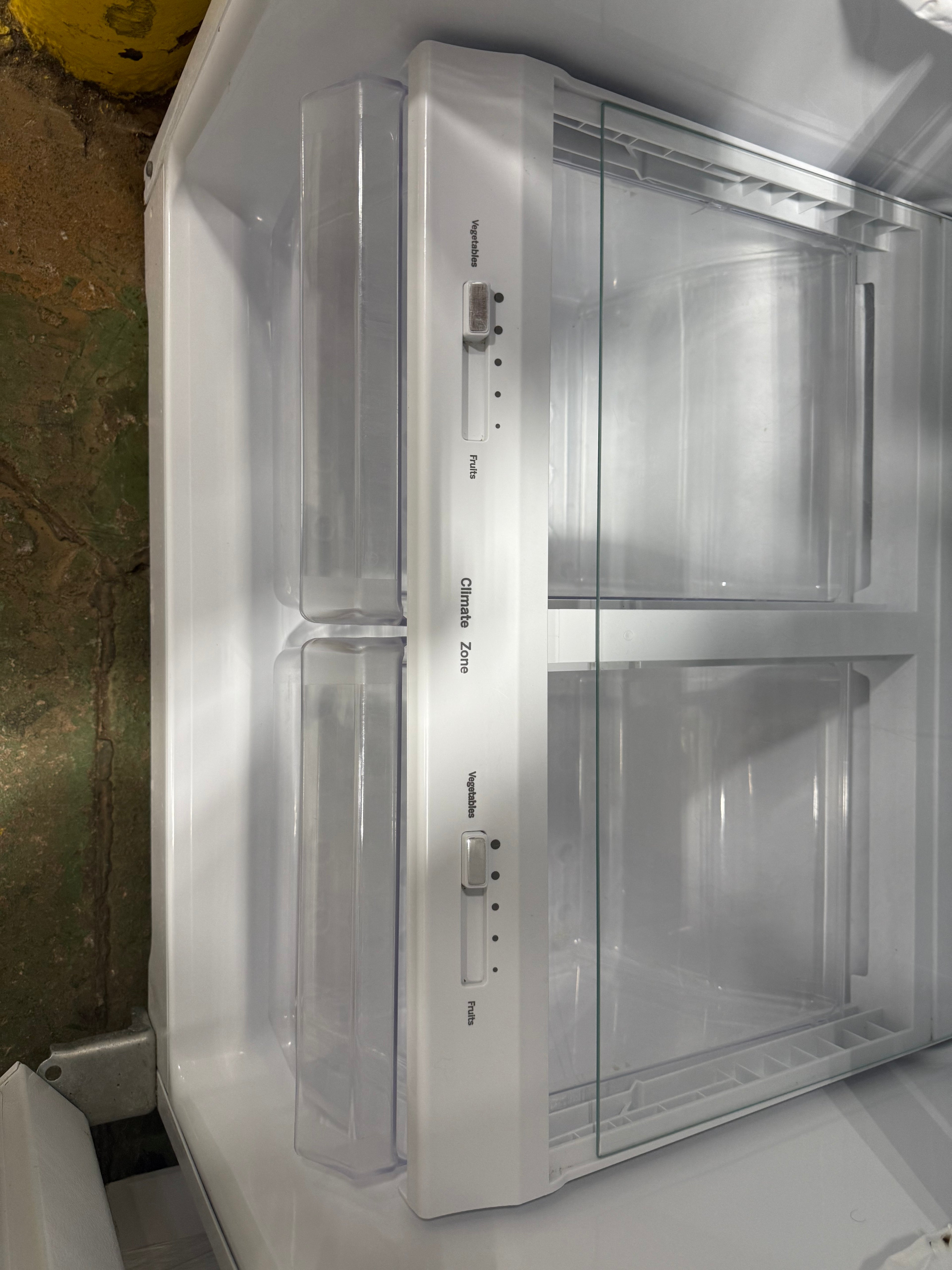 Interior view showing adjustable glass shelves inside GE 17.5 cu.ft. refrigerator from SHL