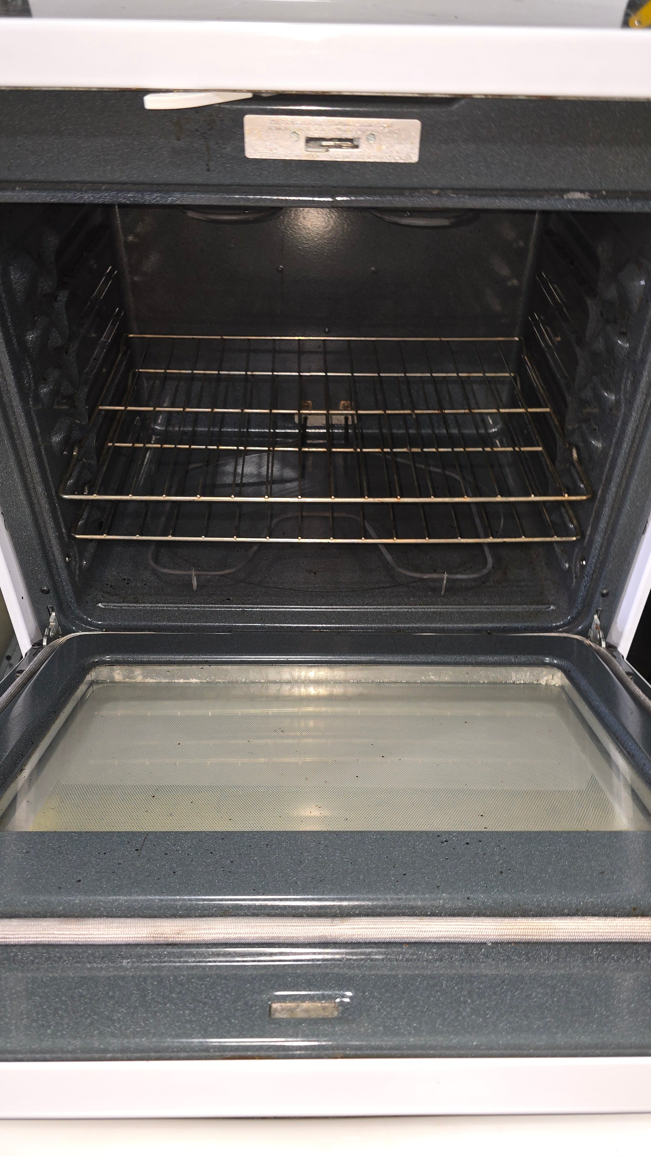 Interior oven view of GE 30-inch glass top stove showing racks and spacious design from SHL