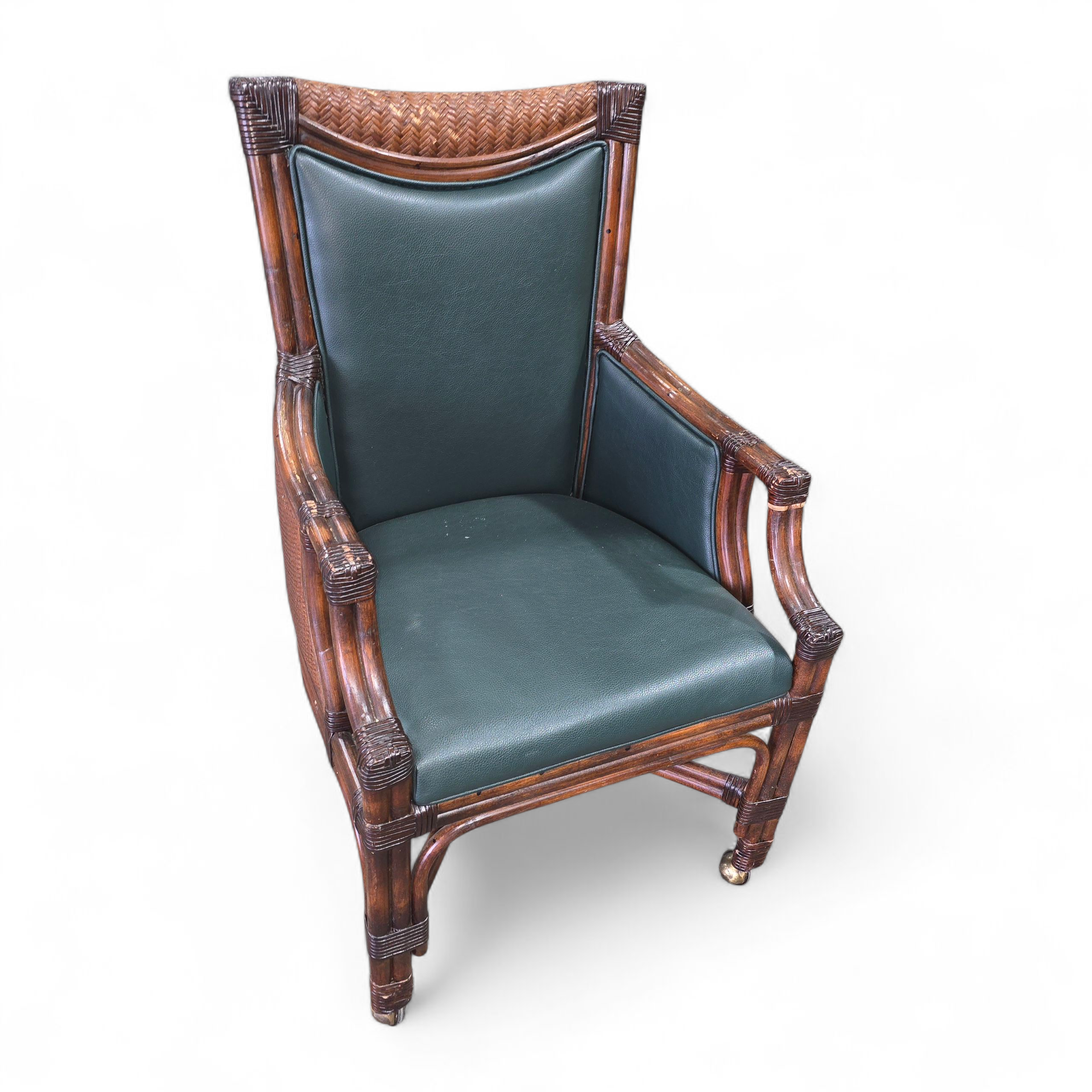 SHL rattan rolling chair with dark green vinyl seat and back, used and in good condition, upscale resort furniture