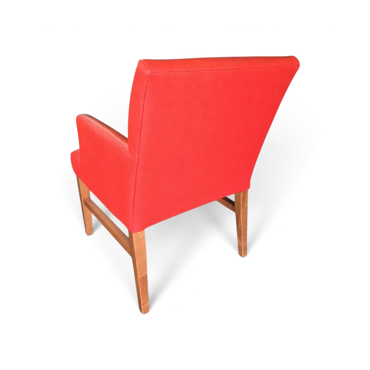 Back view of used red vinyl upholstered dining chair showing solid red backrest and brown wood-finish frame, SHL