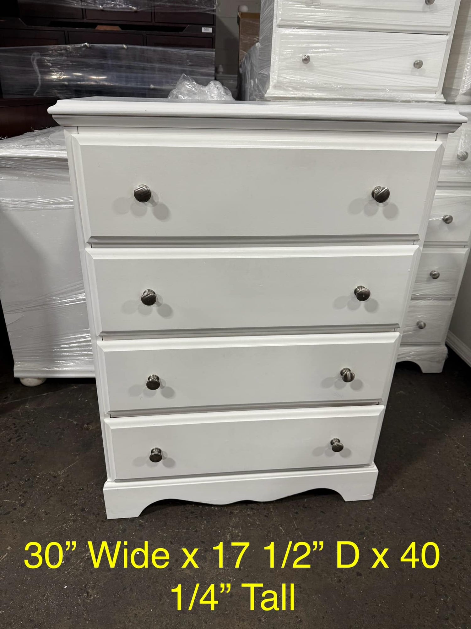 Front view of white 4-drawer chest, coastal or farmhouse style, used and in good condition