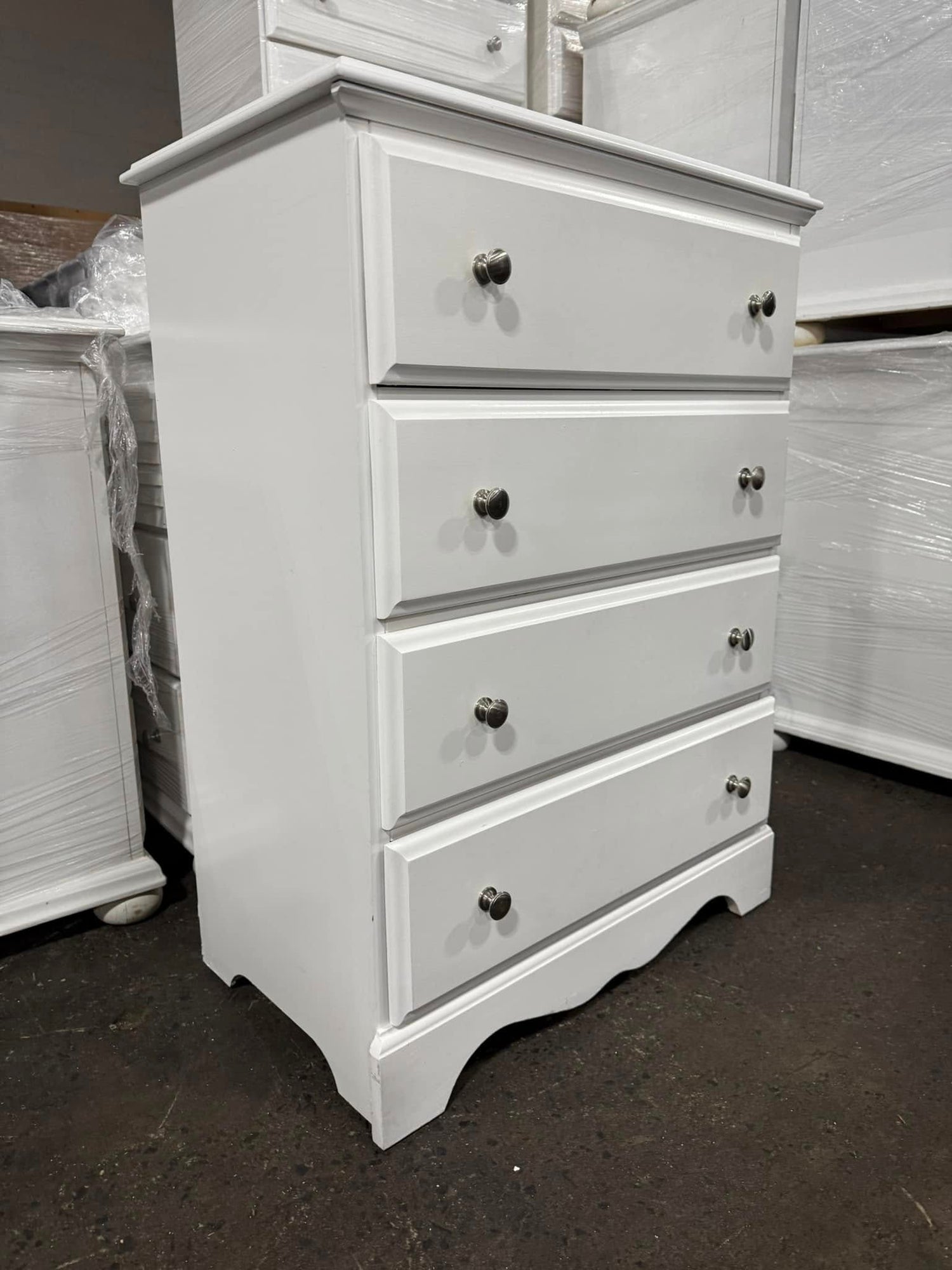 Side view of white 4-drawer chest showing clean lines and white finish