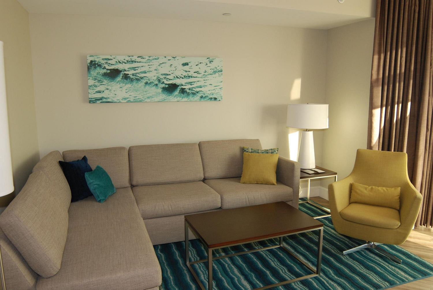Pre-owned Hilton Grand Vacations sectional sleeper sofa in hotel living room – durable, stylish, and affordable furniture liquidation