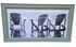Framed wall art of Adirondack chairs on the beach by the ocean, used and in good condition