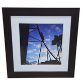 Black framed print of people on a roller coaster measuring 29.5 x 29.5, used and in good condition