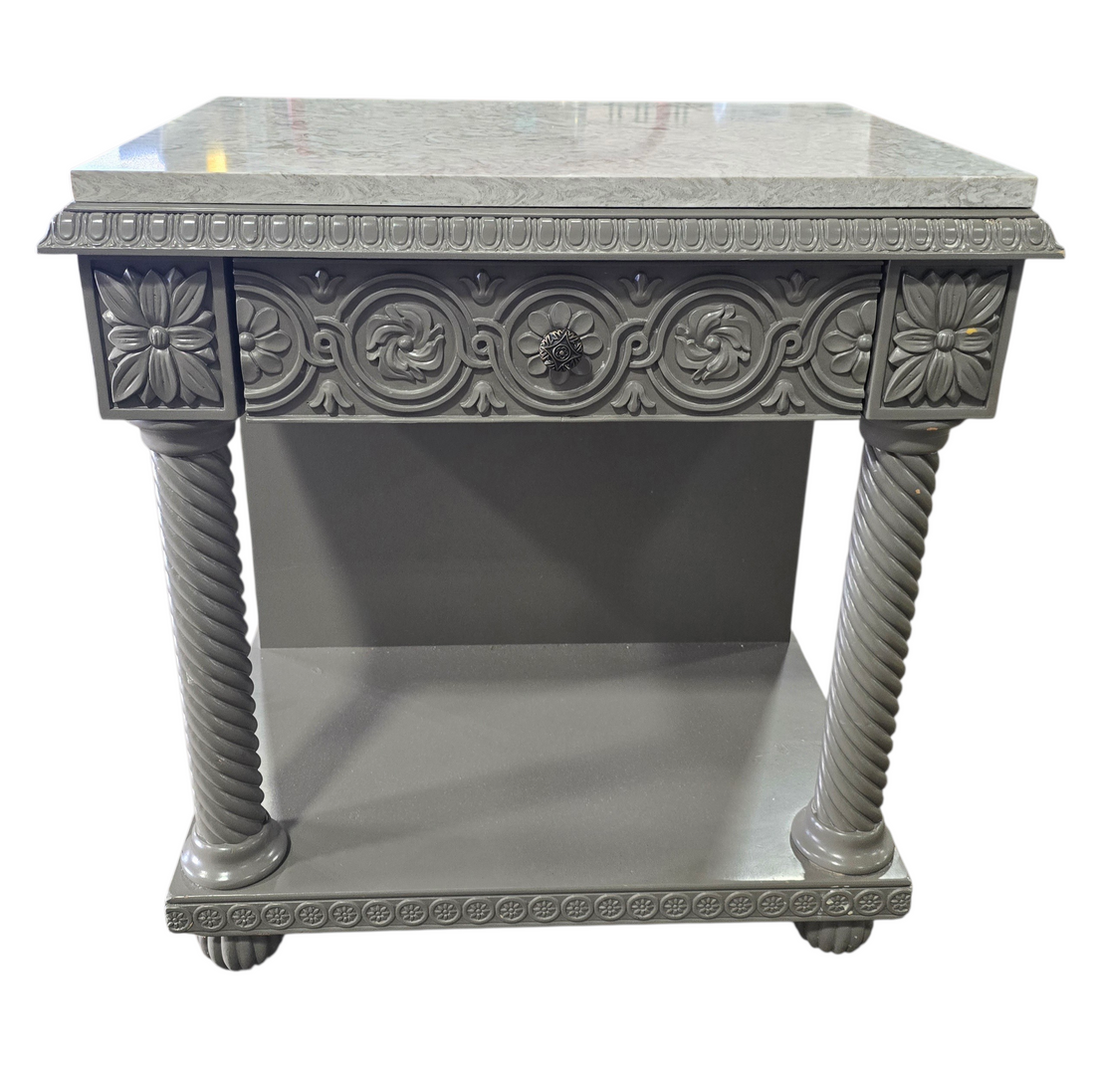Front view of carved wood nightstand with granite surface