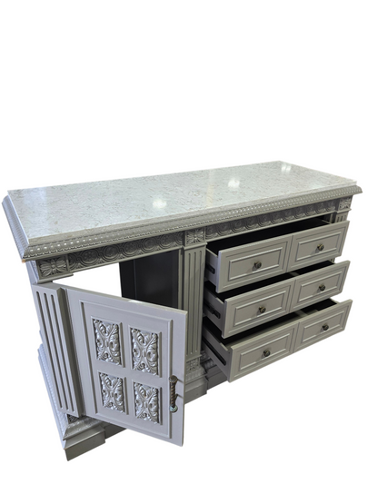 Carved wood TV dresser with white granite top and cabinet storage measuring 66 x 24 x 41, used and in good condition