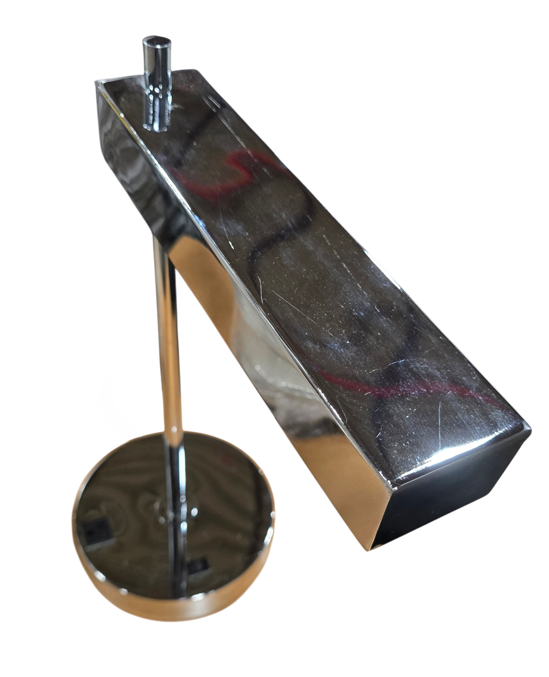 Close-up of chrome desk lamp base showing built-in power outlet