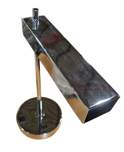 Close-up of chrome desk lamp base showing built-in power outlet