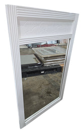 Angled view of coastal white shell motif wall mirror measuring 27.5 x 44 inches