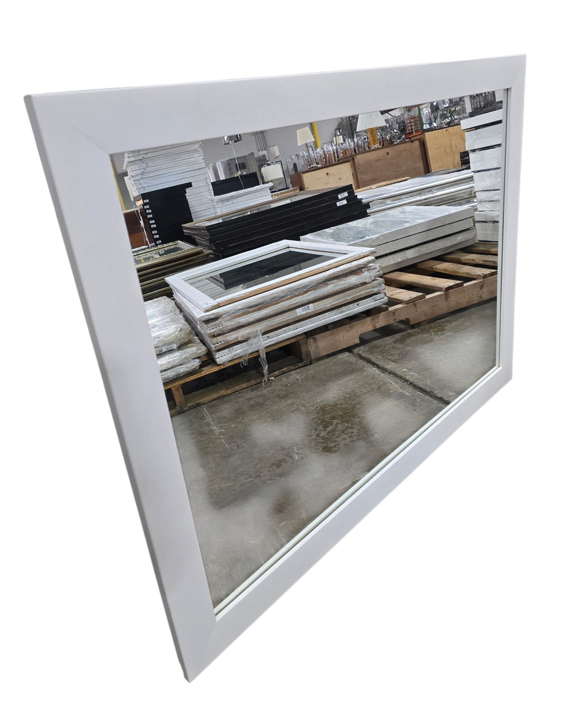 Angled view of contemporary white framed rectangular wall mirror measuring 44 x 33 inches