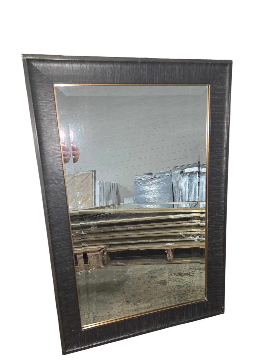 Dark brown framed wall mirror measuring 24 x 36 with bronze inner trim