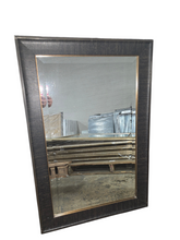 Dark brown framed wall mirror measuring 24 x 36 with bronze inner trim