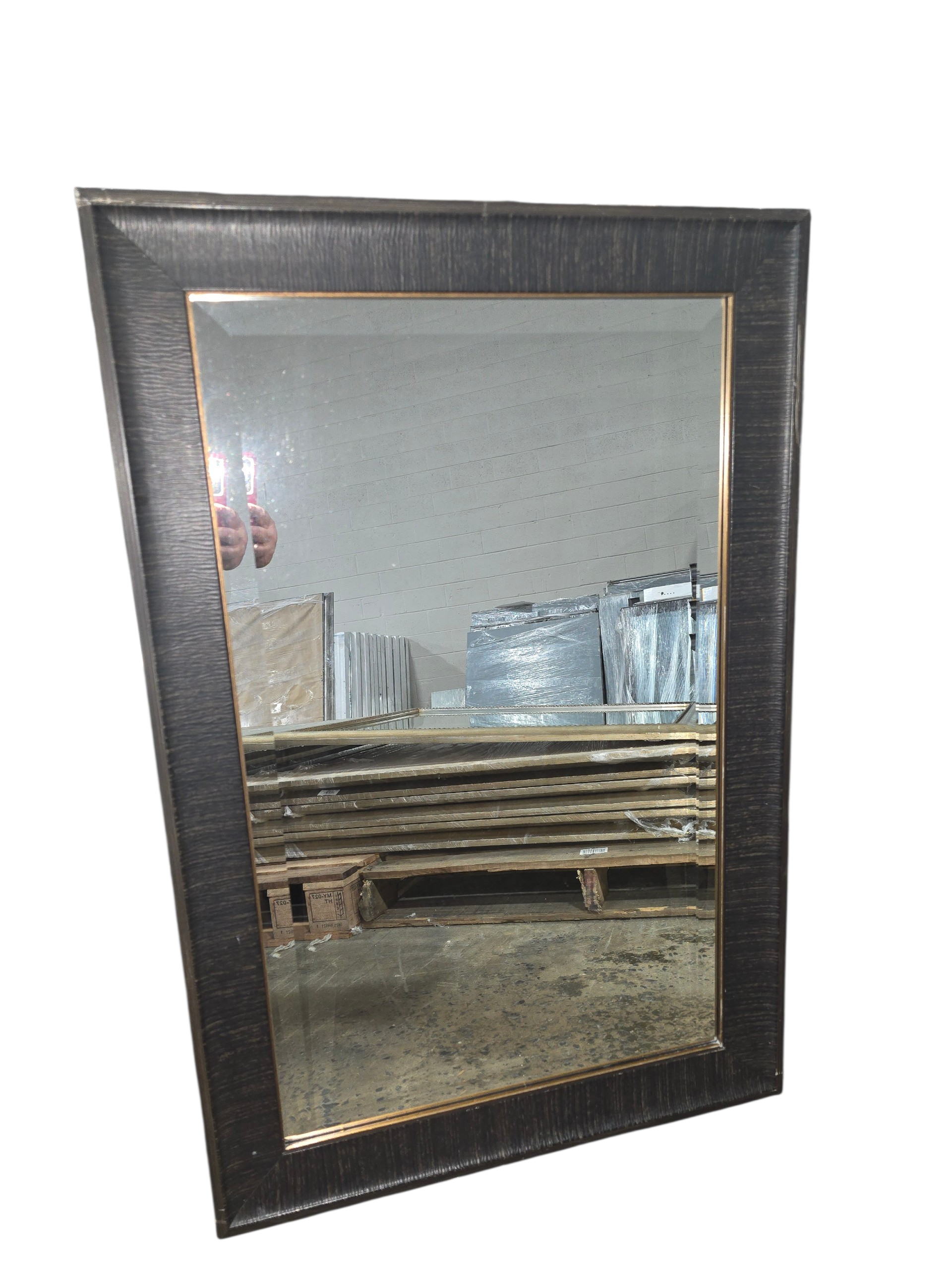 Dark brown framed wall mirror measuring 24 x 36 with bronze inner trim
