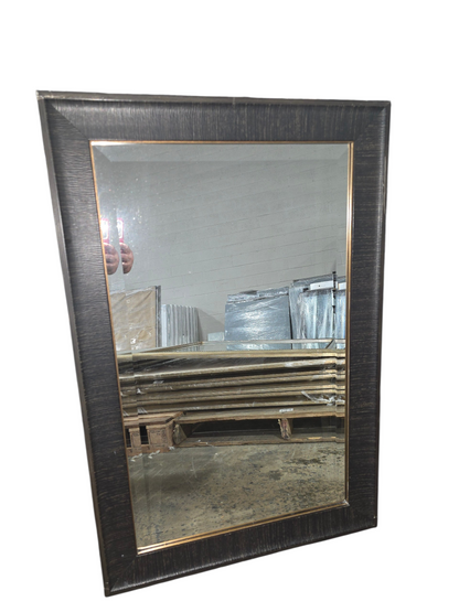 Dark brown framed wall mirror measuring 24 x 36 with bronze inner trim