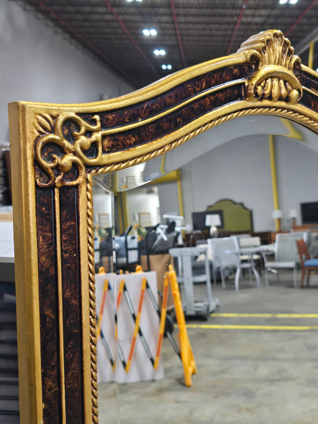 Close-up of dark brown and gold frame detail on mirror
