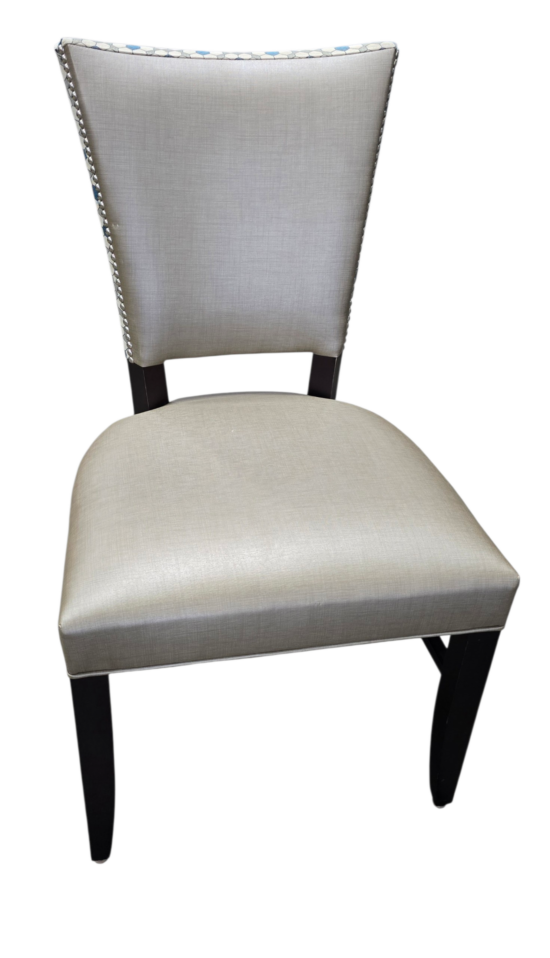 Front view of upholstered dining chair with nailhead trim