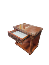 Close-up of inset glass top surface on ornate nightstand