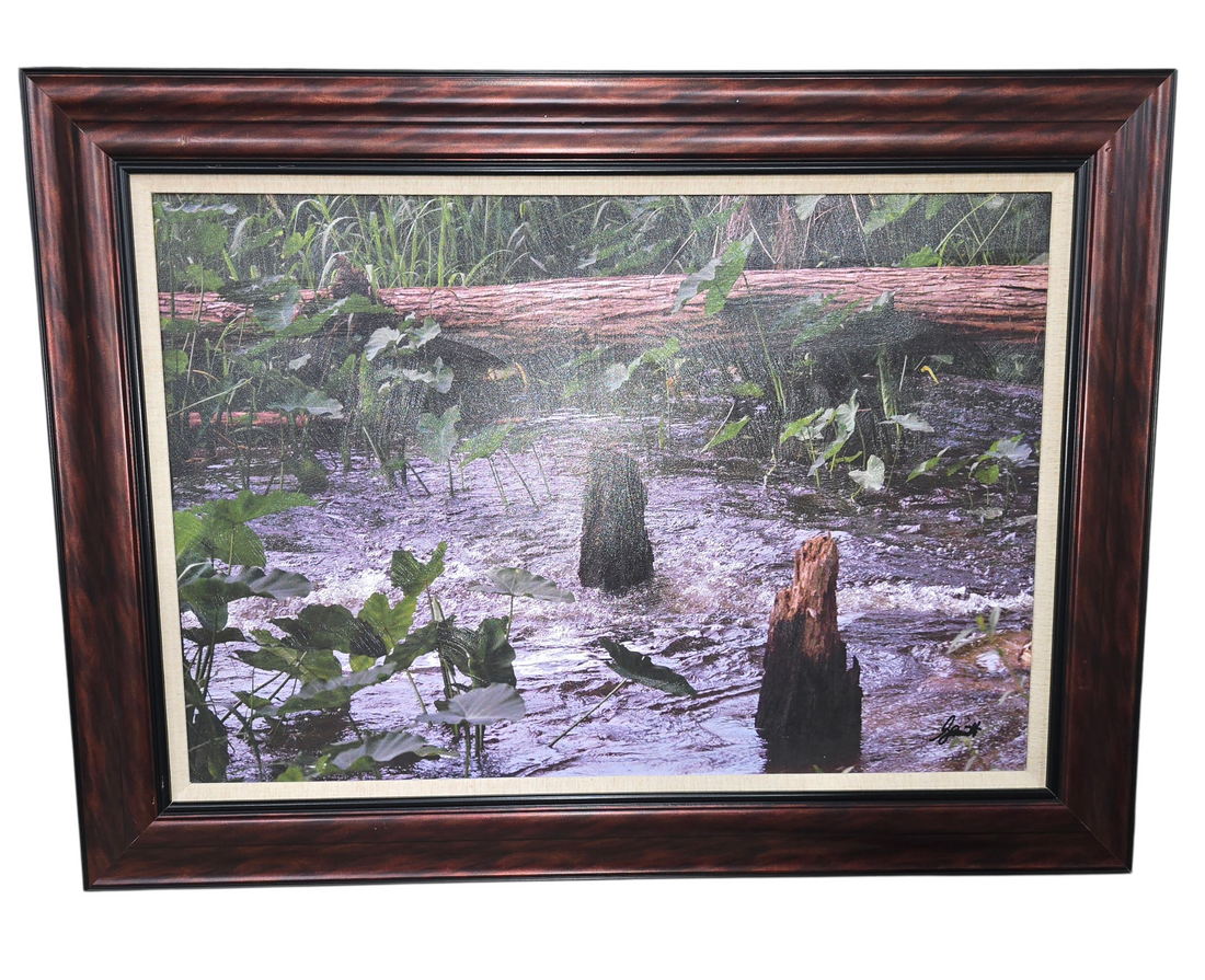 Square framed wall art of stream with plants and logs