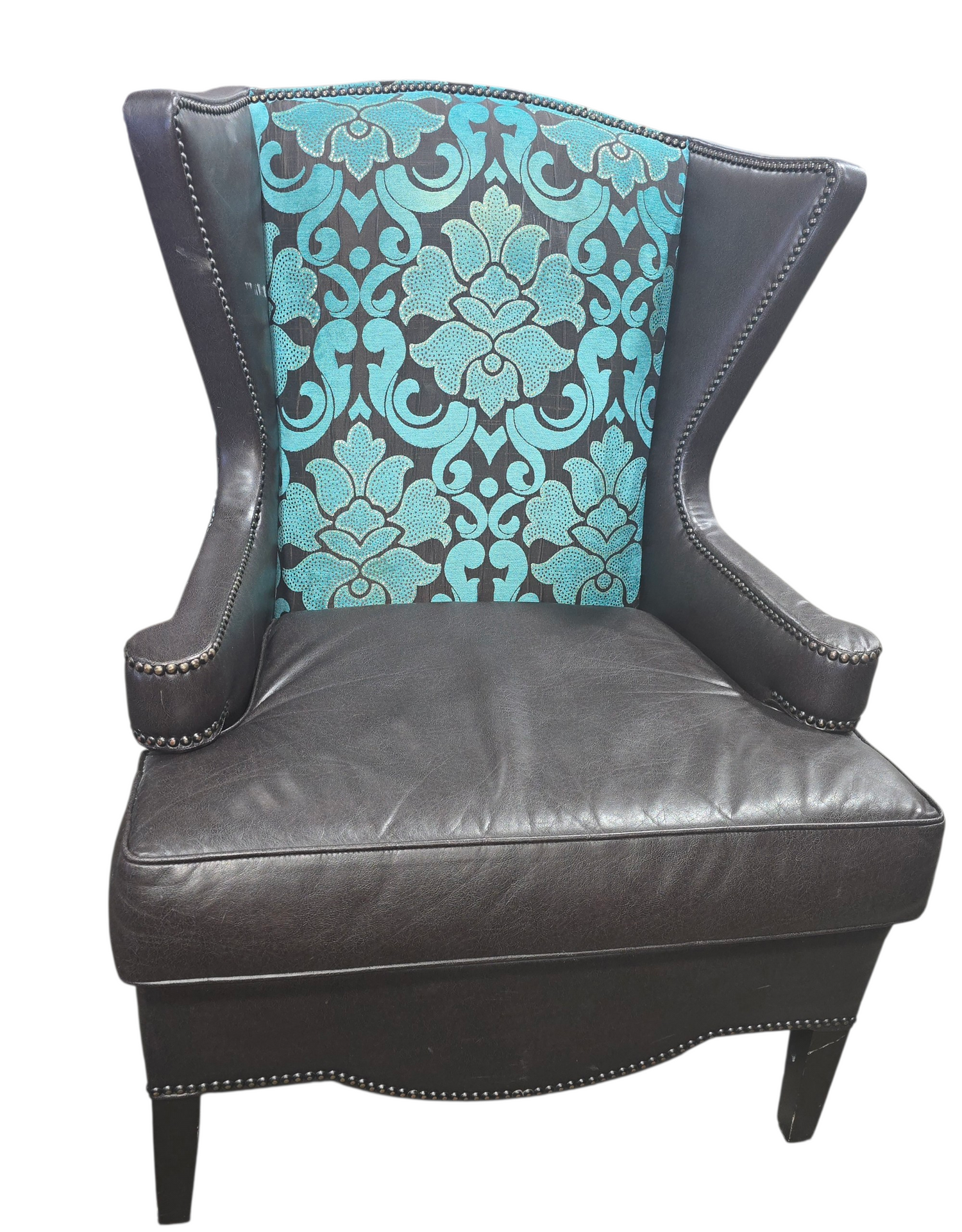Leather wingback accent chair with damask backrest upholstery and dark brown leather seat and arms, used and in good condition
