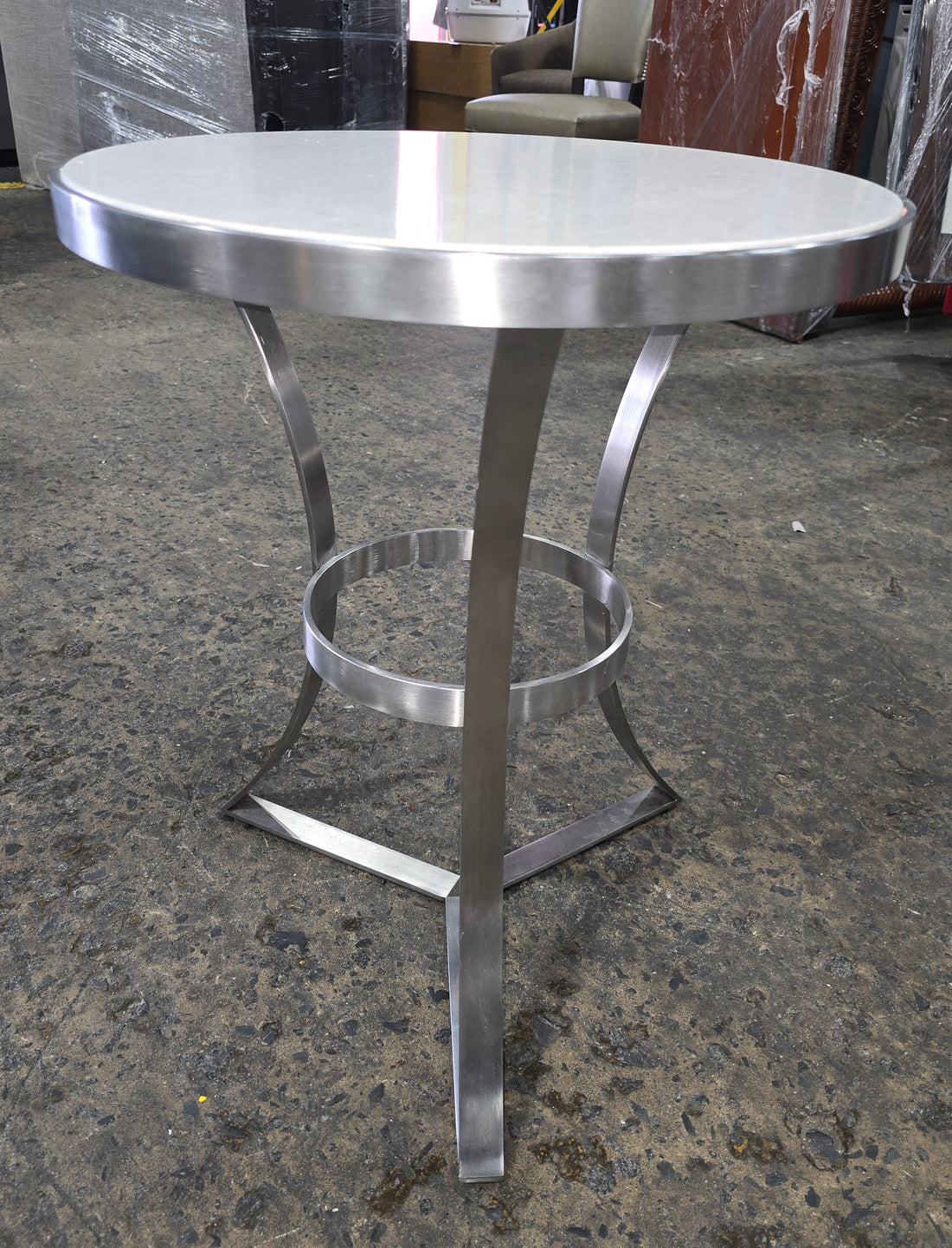 Close-up of sleek metal base detail on side table