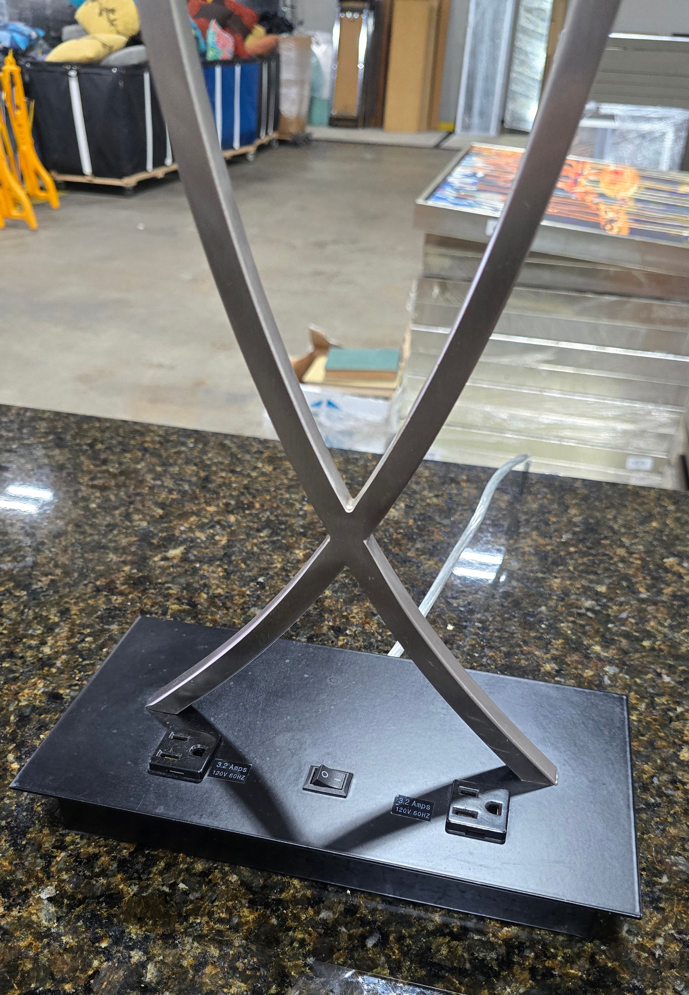 SHL close-up of base with two power outlets on metal criss-cross lamp