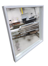 Angled view of modern white framed square wall mirror measuring 28 x 28 x 2 inches