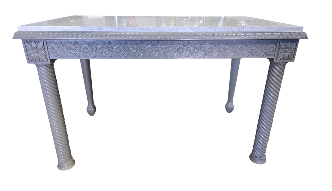Front view of gray painted carved wood desk with granite surface