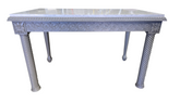 Front view of gray painted carved wood desk with granite surface