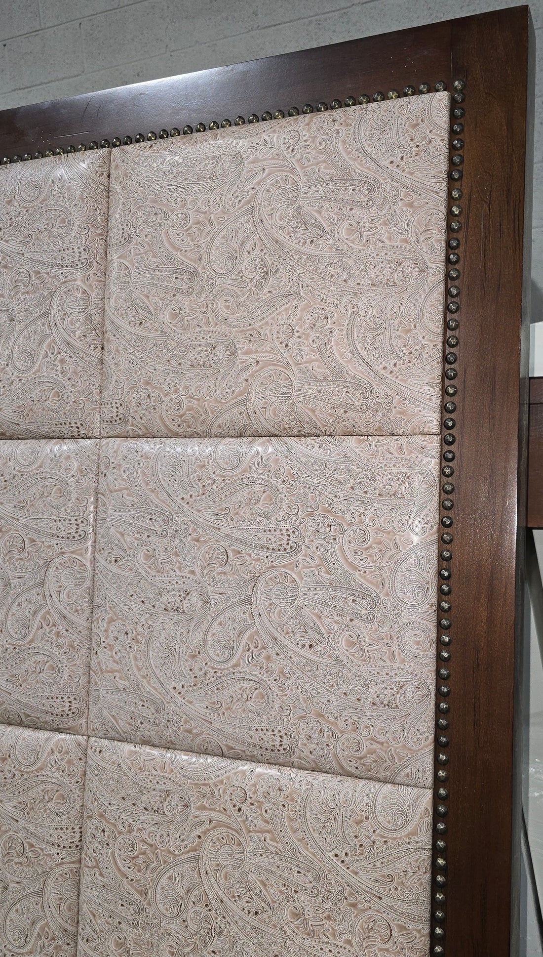 Close-up of paisley fabric detail on headboard