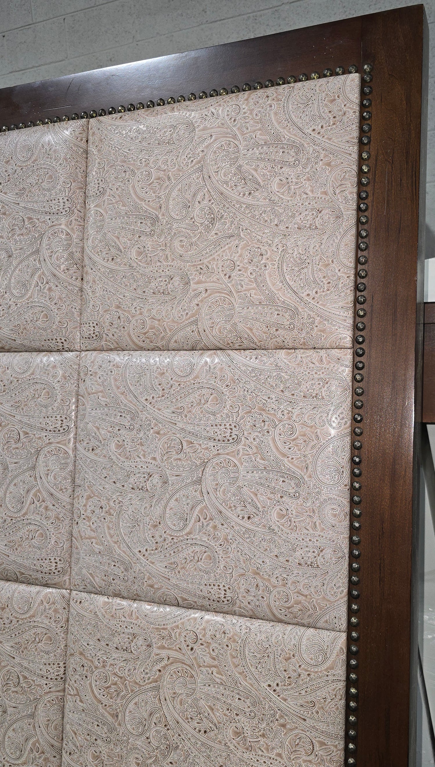 Close-up of paisley fabric detail on headboard