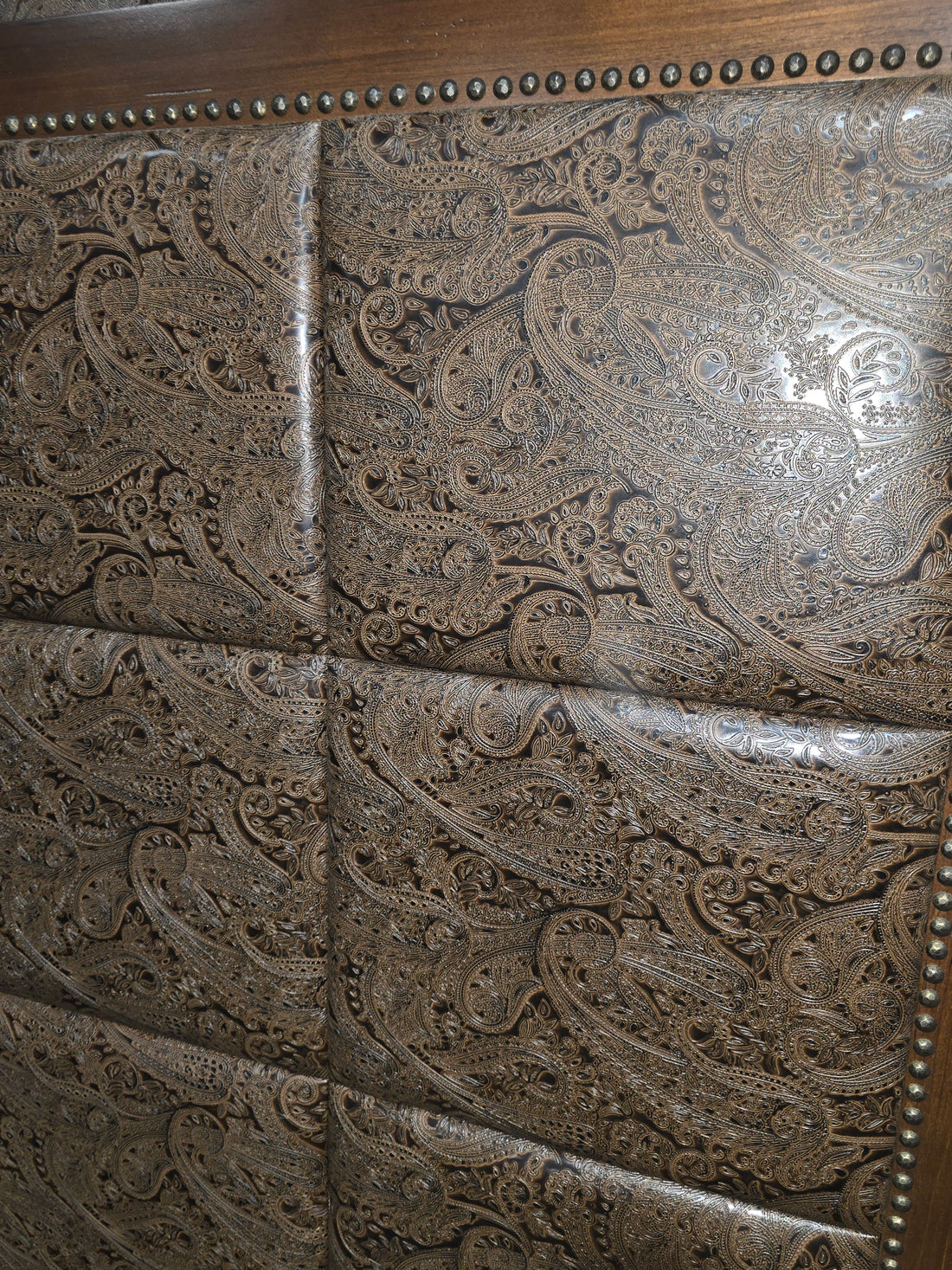 Close-up of paisley fabric detail on headboard
