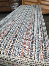 Used upholstered bench with textured patterned fabric