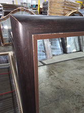 Decorative mirror with bronze inner trim detail 31 1/4 x 43 1/4