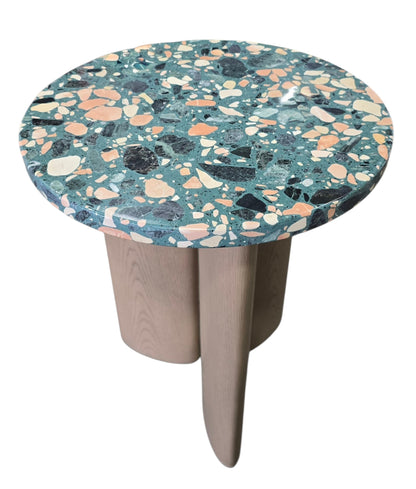 Round terrazzo side table featuring a contemporary sculptural wood base and multicolor terrazzo tabletop