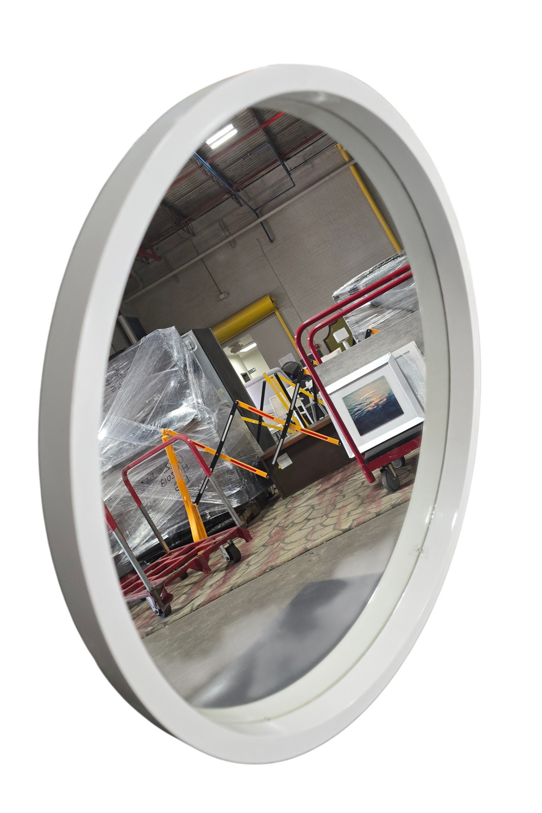 Side angle view of round white framed mirror
