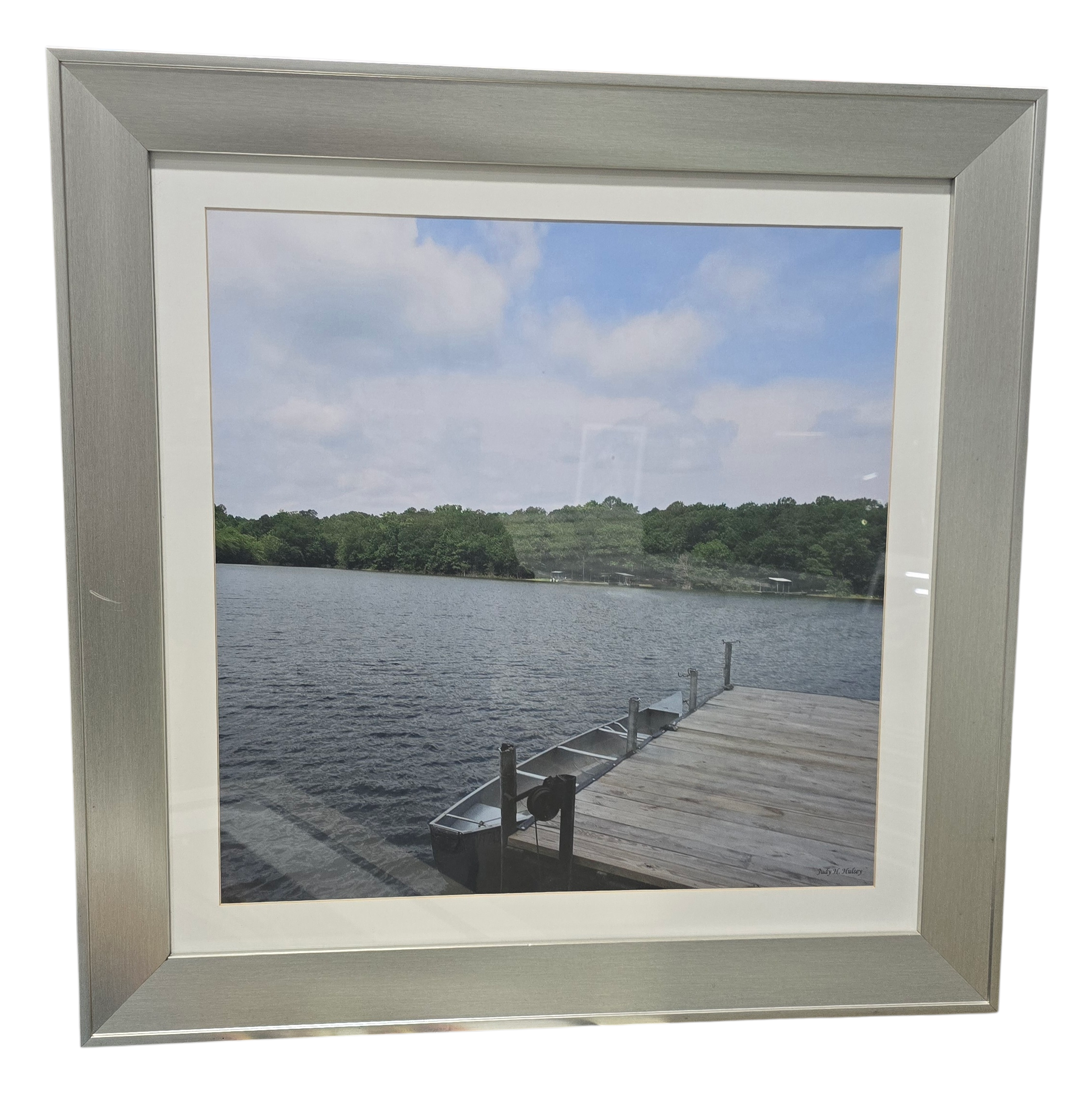 Framed wall art of small boat pulled up to a dock, used and in good condition