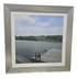 Framed wall art of small boat pulled up to a dock, used and in good condition
