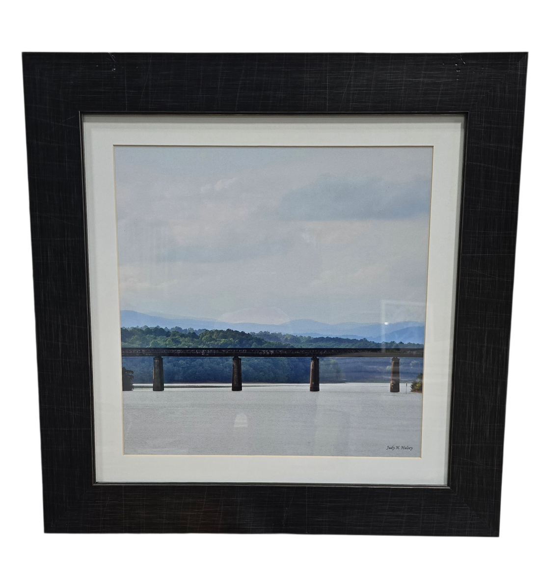 Framed print of trestle over a body of water, used and in good condition