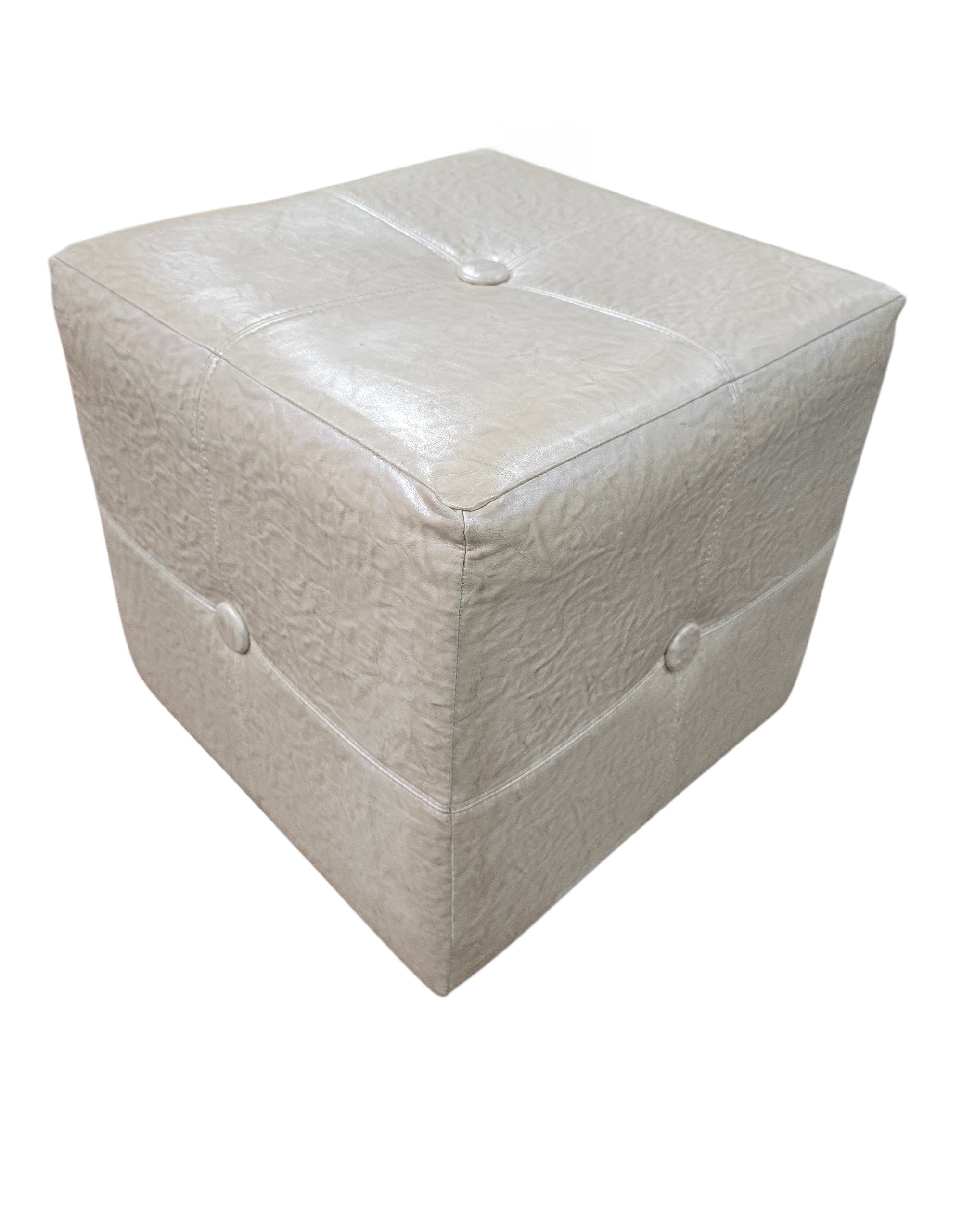 SHL angled view of quality used 18 inch cream faux leather cube ottoman featuring upholstered sides and button tufted top sourced from an upscale resort