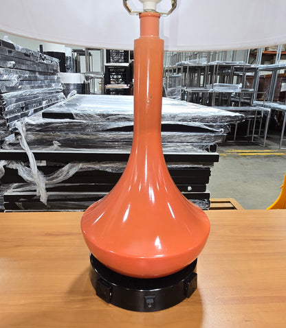 SHL close-up of coral ceramic table lamp base featuring dual built-in 120V power outlets sourced from an upscale resort